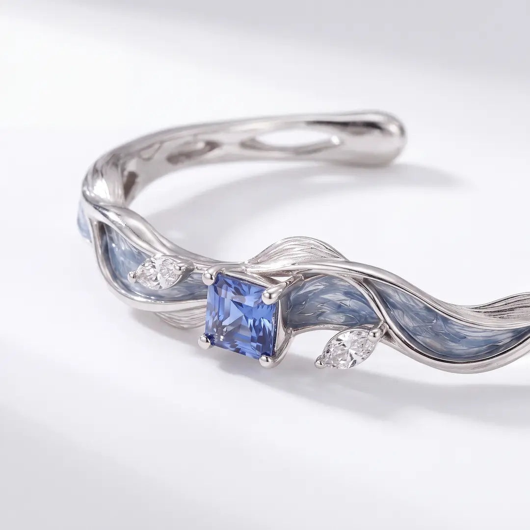 Aiko Tanaka High Jewelry No. 021 ring, a silver wave band with blue enamel and a square blue stone on grey silk