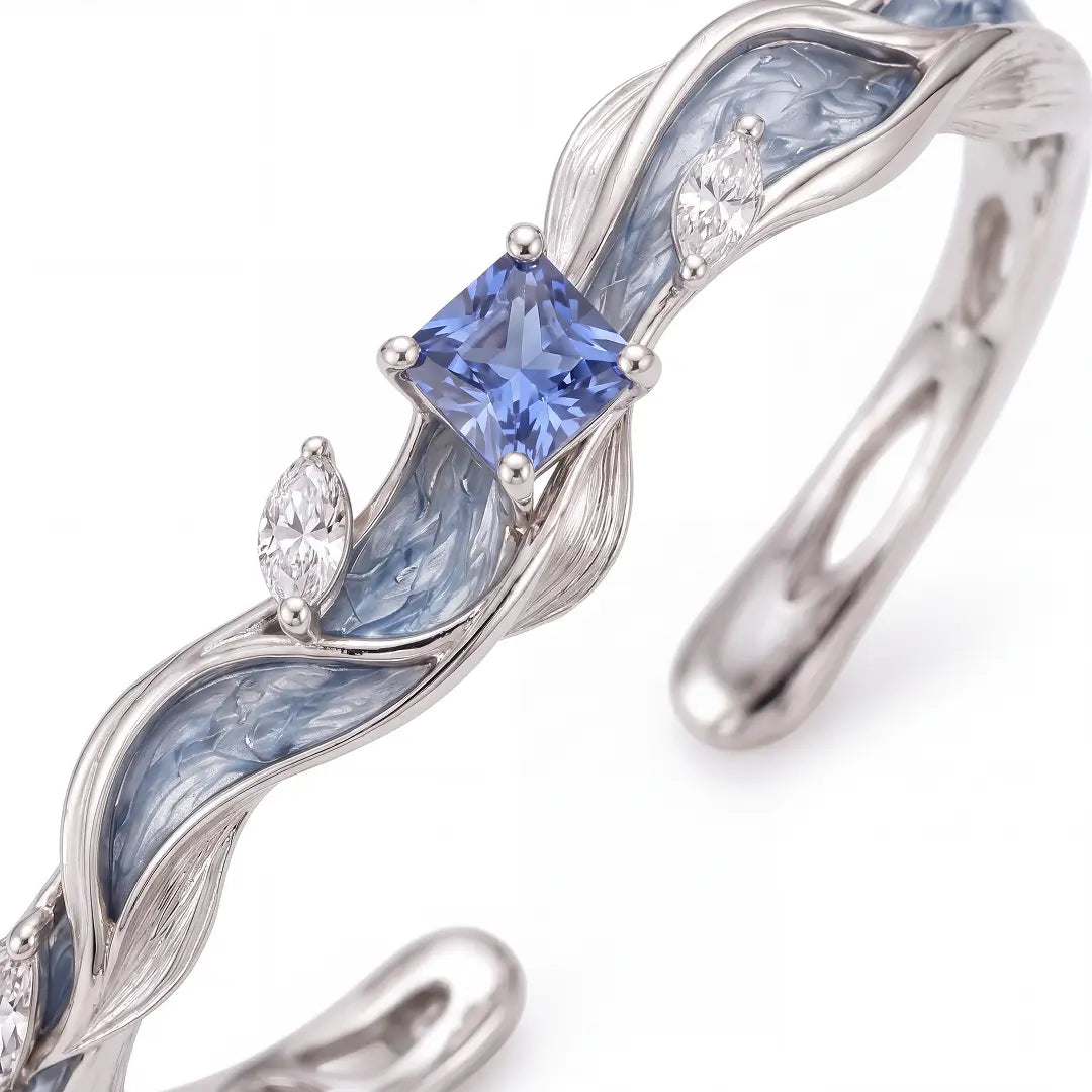 Aiko Tanaka High Jewelry No. 021 ring close-up, an open silver band with blue enamel waves and a square blue stone