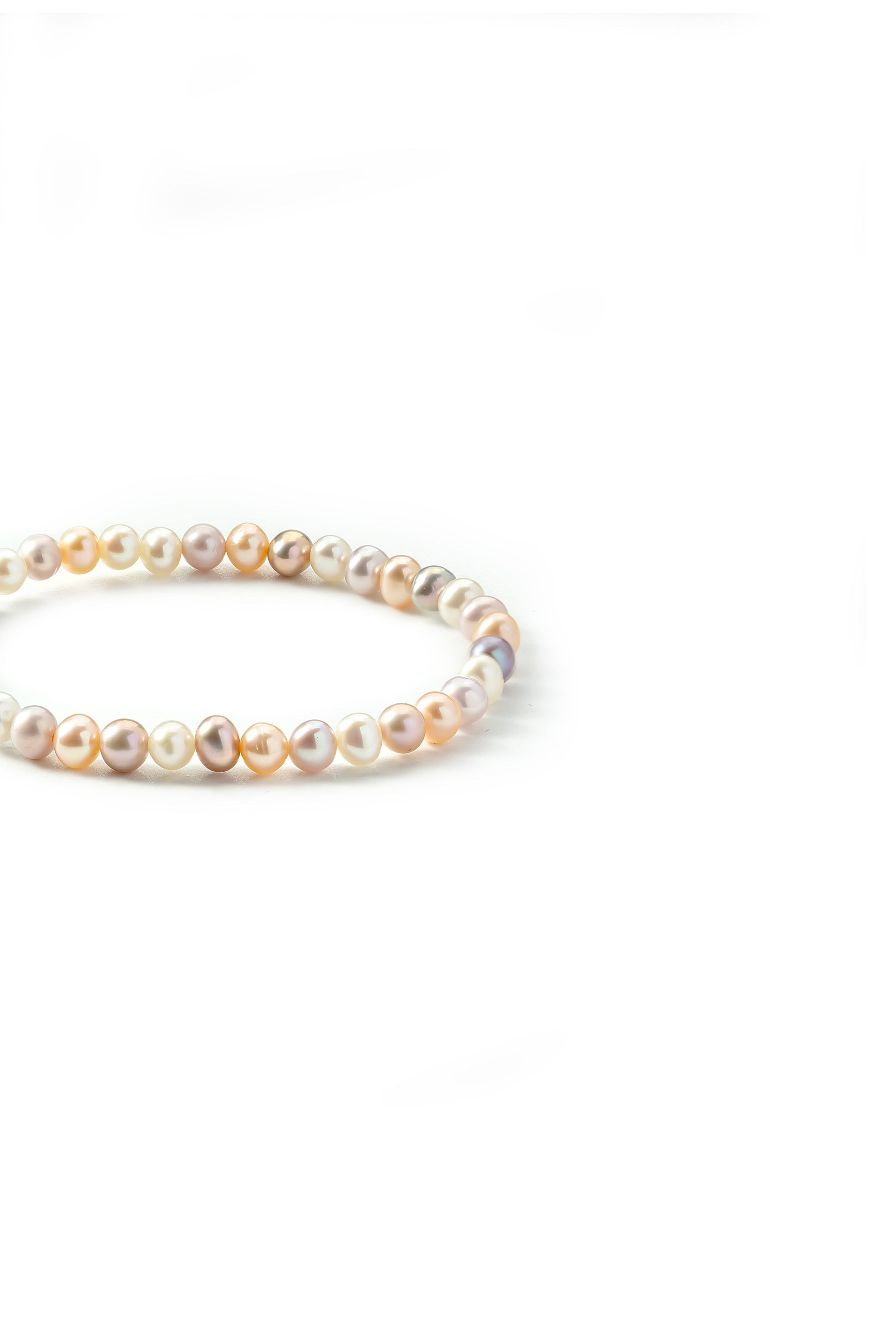 Side view of the Aiko Tanaka Nagomi bracelet of mixed white, peach and lavender pearls on a white background