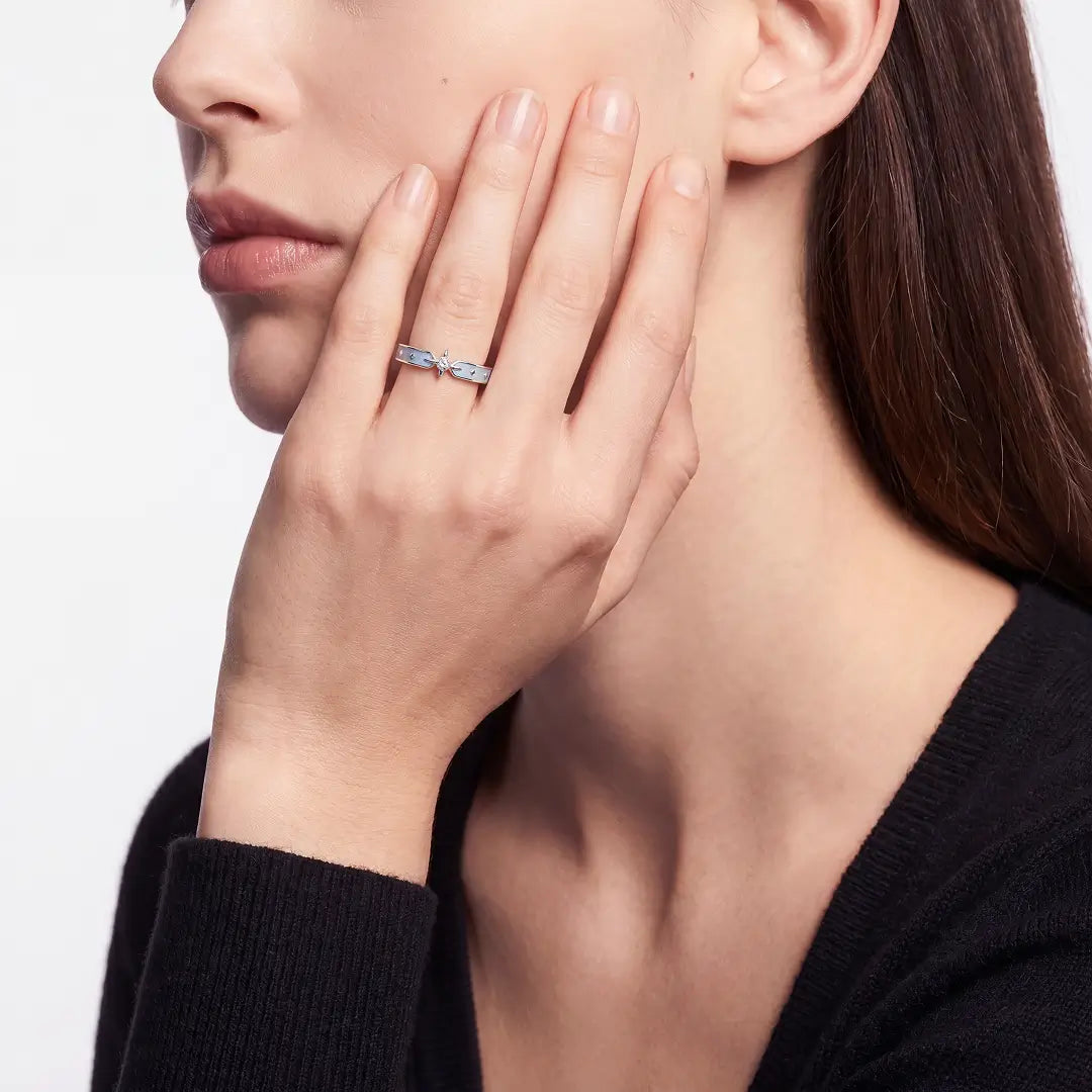 Woman resting her hand on her cheek wearing the Aiko Tanaka Hoshikage slim silver star ring
