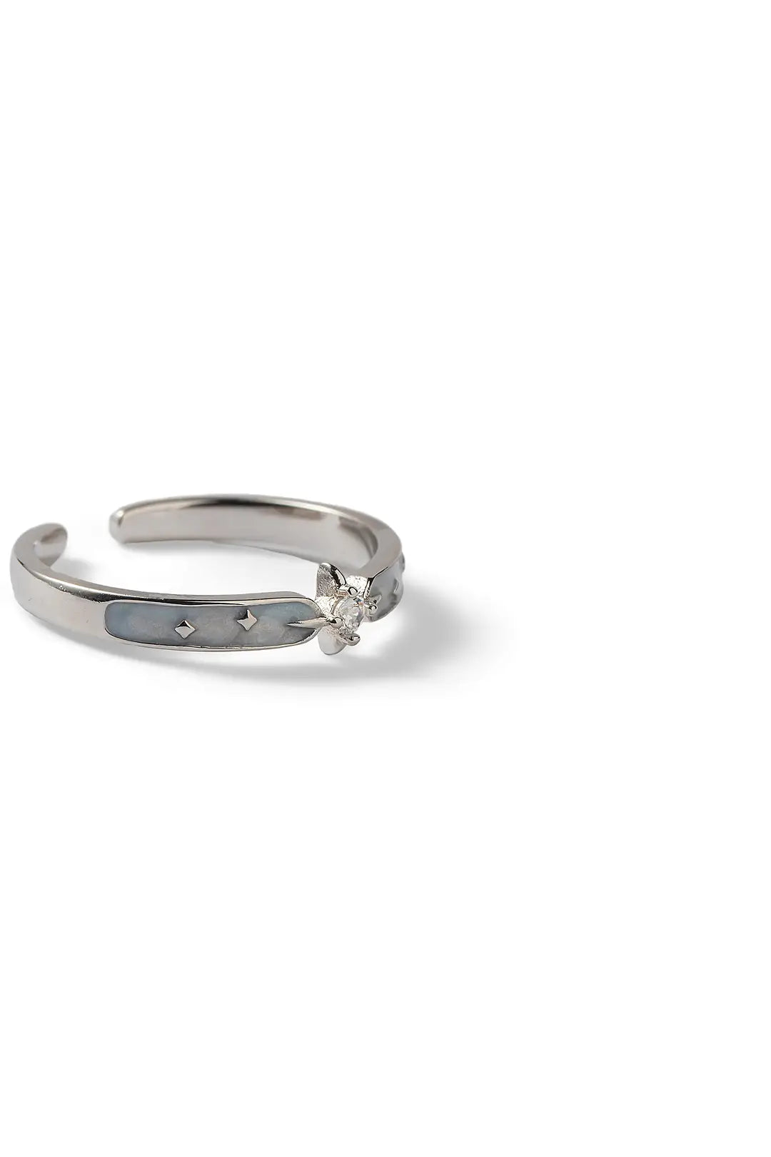 Side view of the Aiko Tanaka Hoshikage open silver ring with a star detail and pave crystals, on white