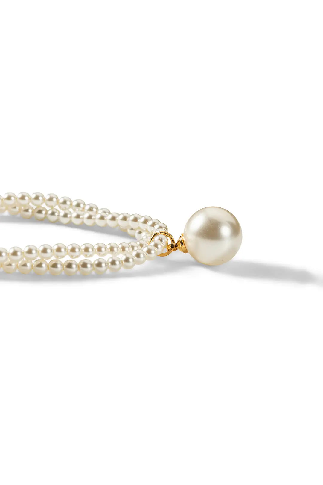 Aiko Tanaka Tsukishiro necklace close-up, double strands of tiny pearls meeting at a large white pearl, white background