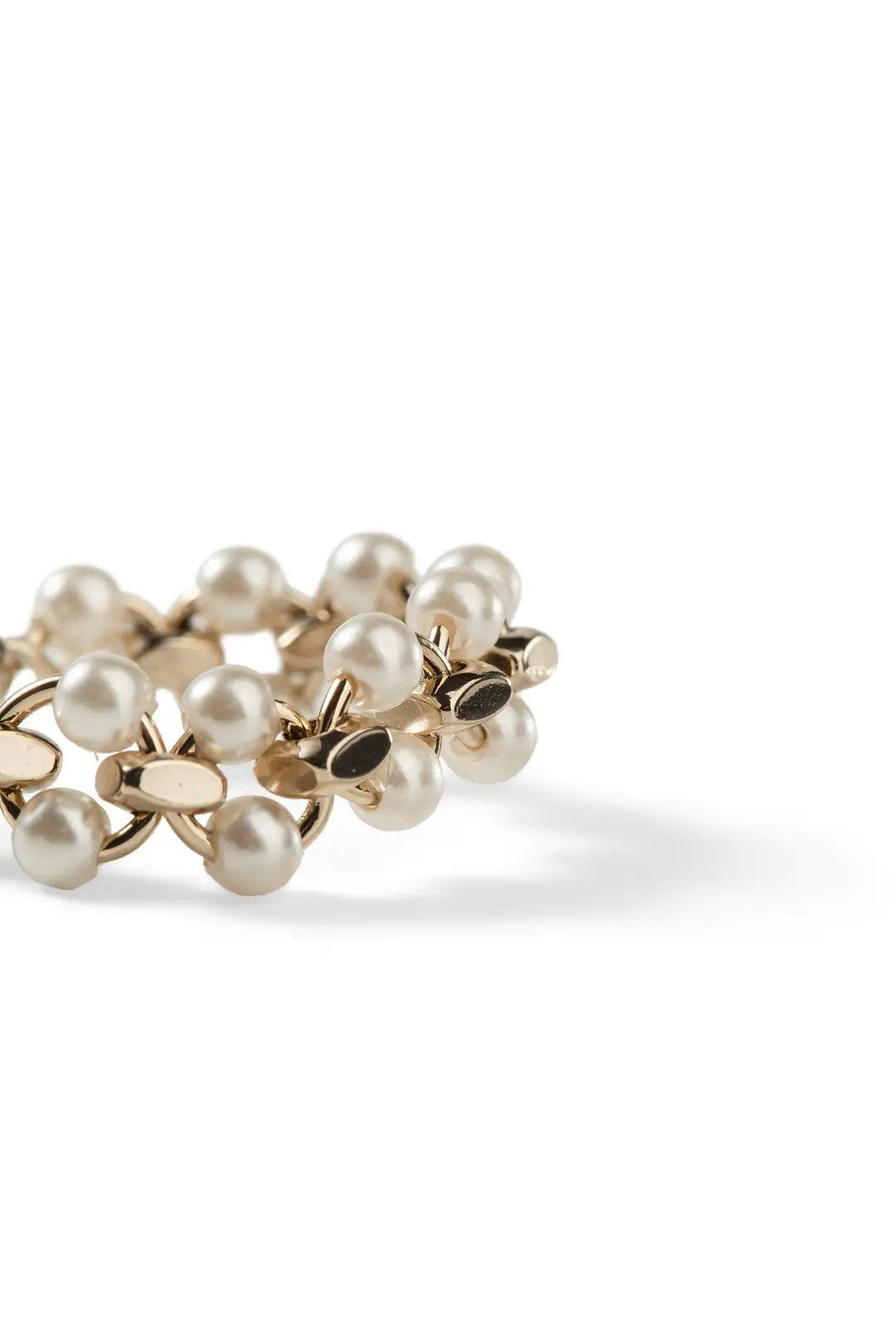 Aiko Tanaka Enrei ring, a gold band of clustered white pearls and gold flowers, shown on a white background