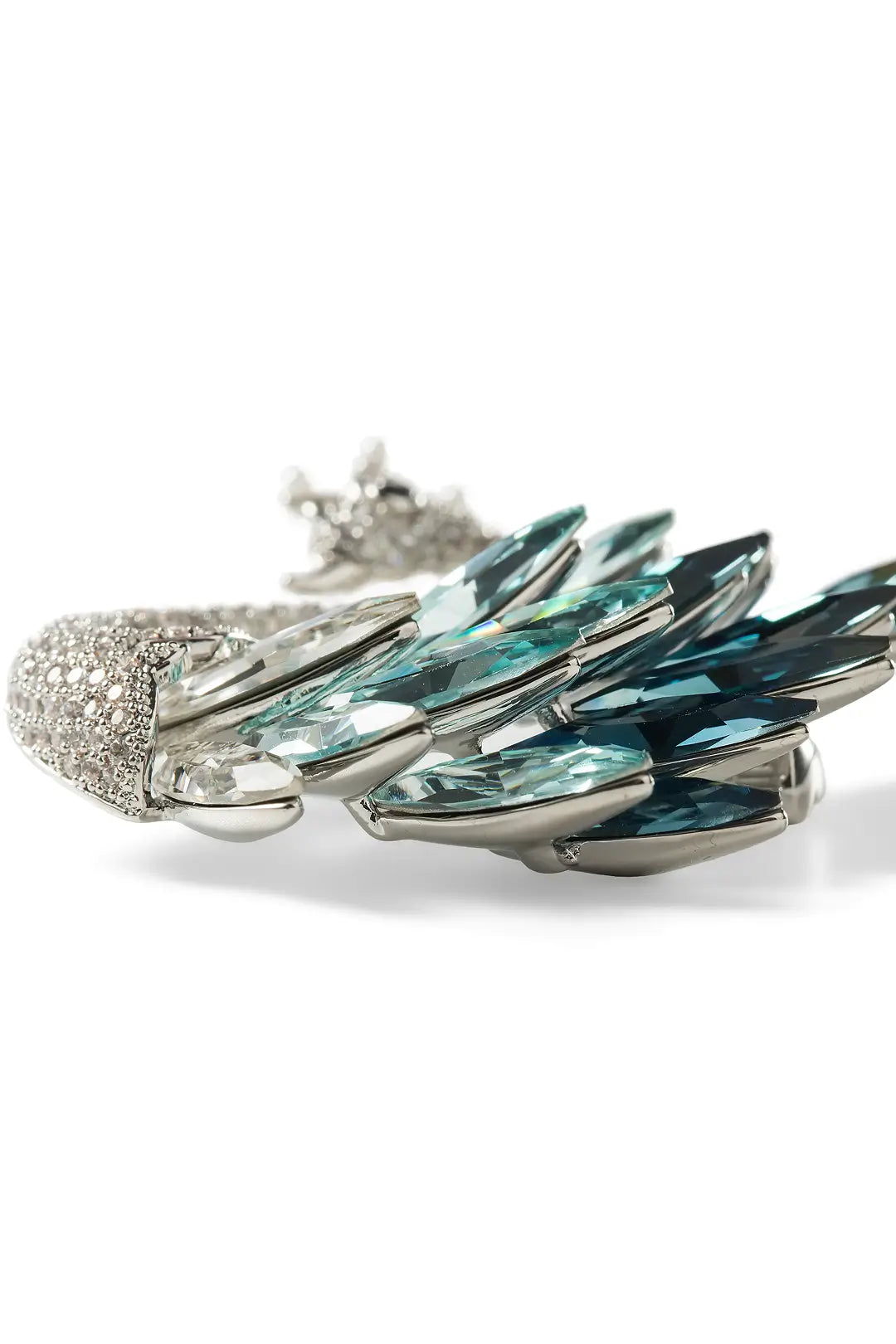 Aiko Tanaka Shiraha brooch close-up, a pavé silver swan with layered teal crystal wing feathers, white background