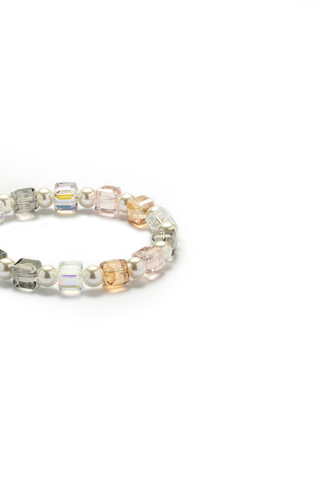 Side view of the Aiko Tanaka Kosai no Wa bracelet showing pastel pink, amber and clear crystal cubes between pearls