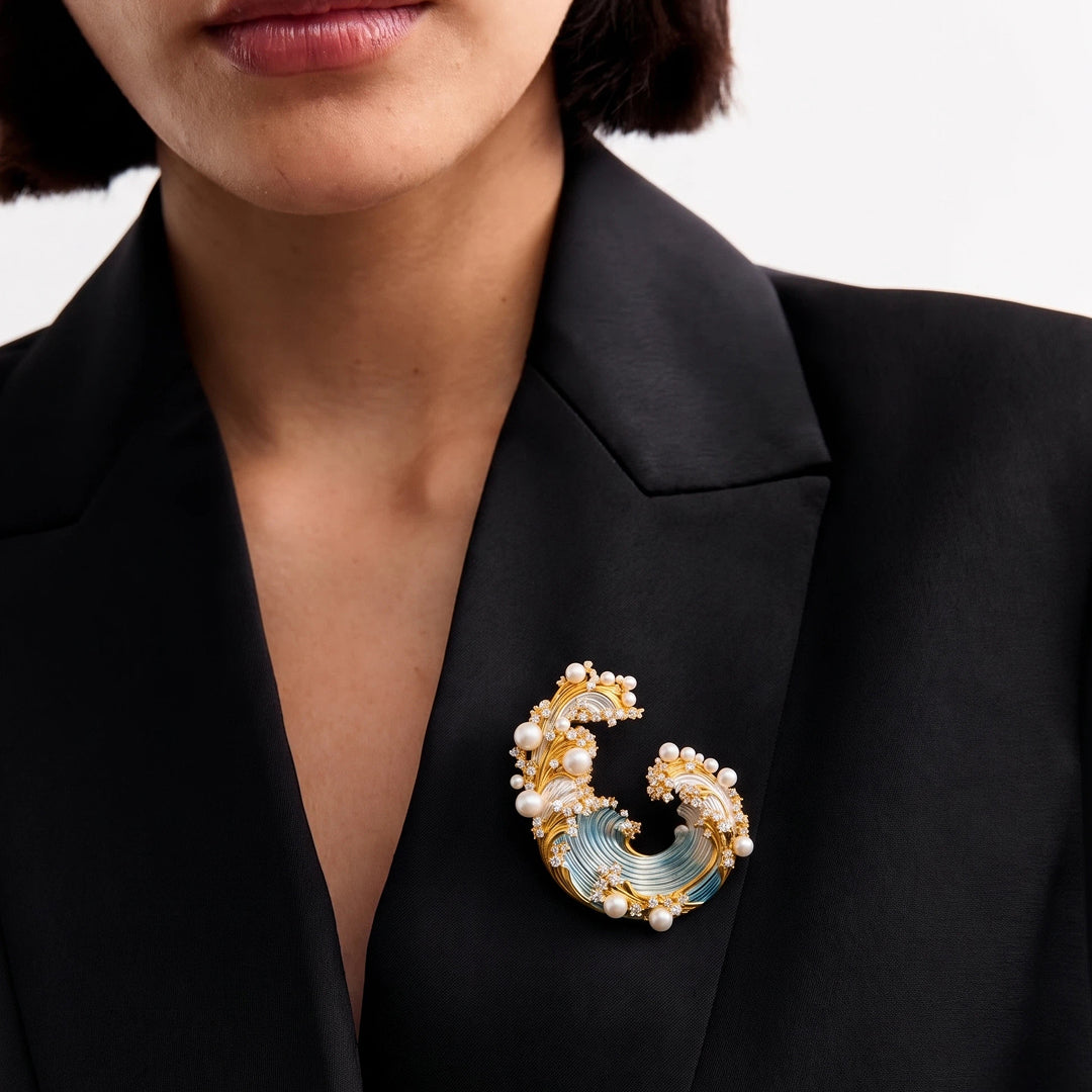 Woman in a black blazer wearing the Aiko Tanaka Shiosai no Wa wave brooch with white pearls on her lapel