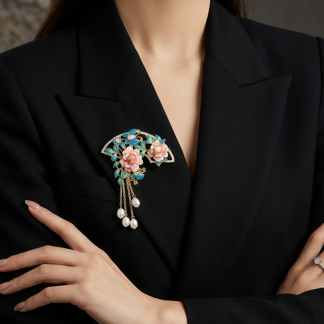 Woman in a black blazer wearing the Aiko Tanaka Hanagasumi pink flower fan brooch with pearl tassels on her lapel