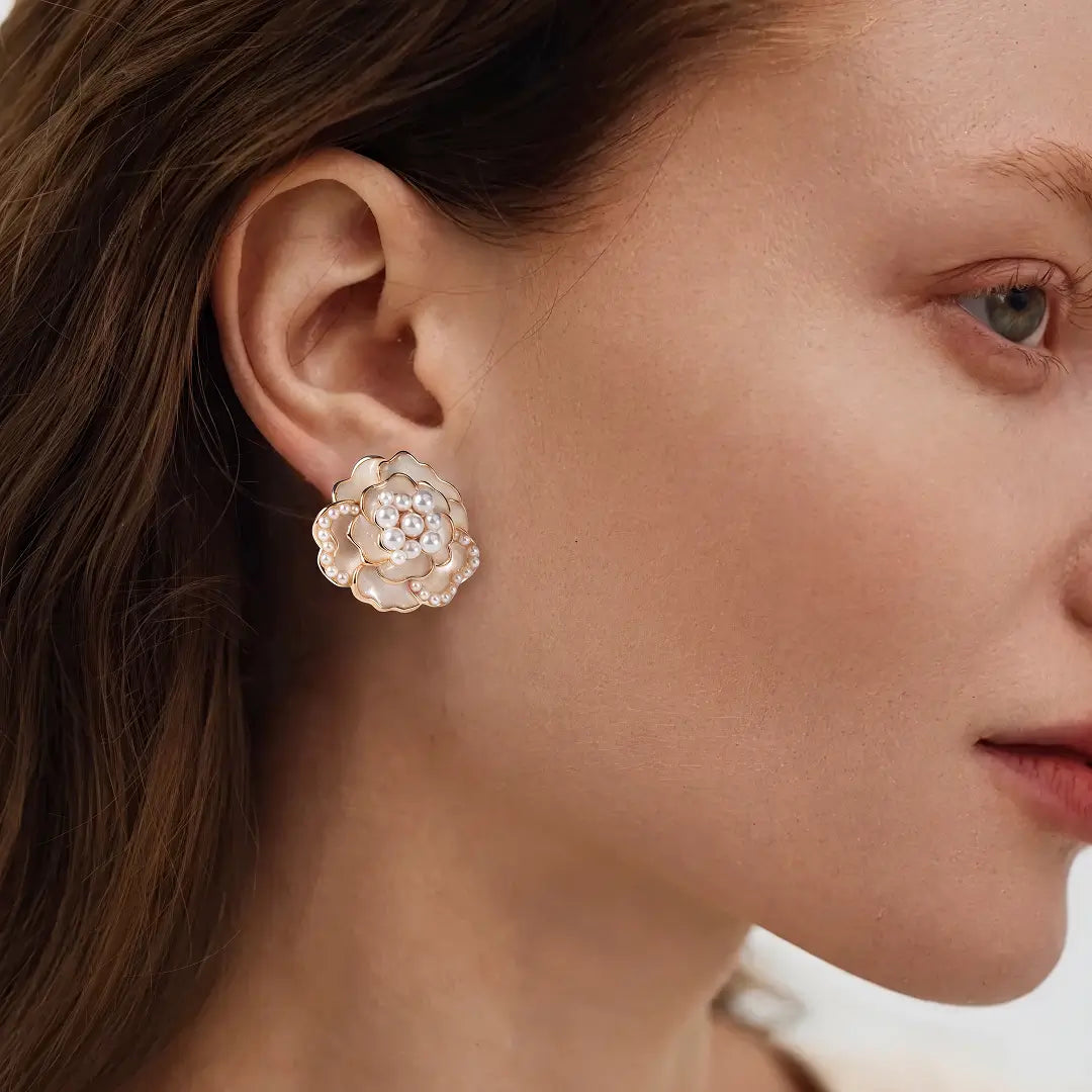 Aiko Tanaka Hanakage earrings, a blush pink crystal rose stud, shown in profile on a model with brown hair