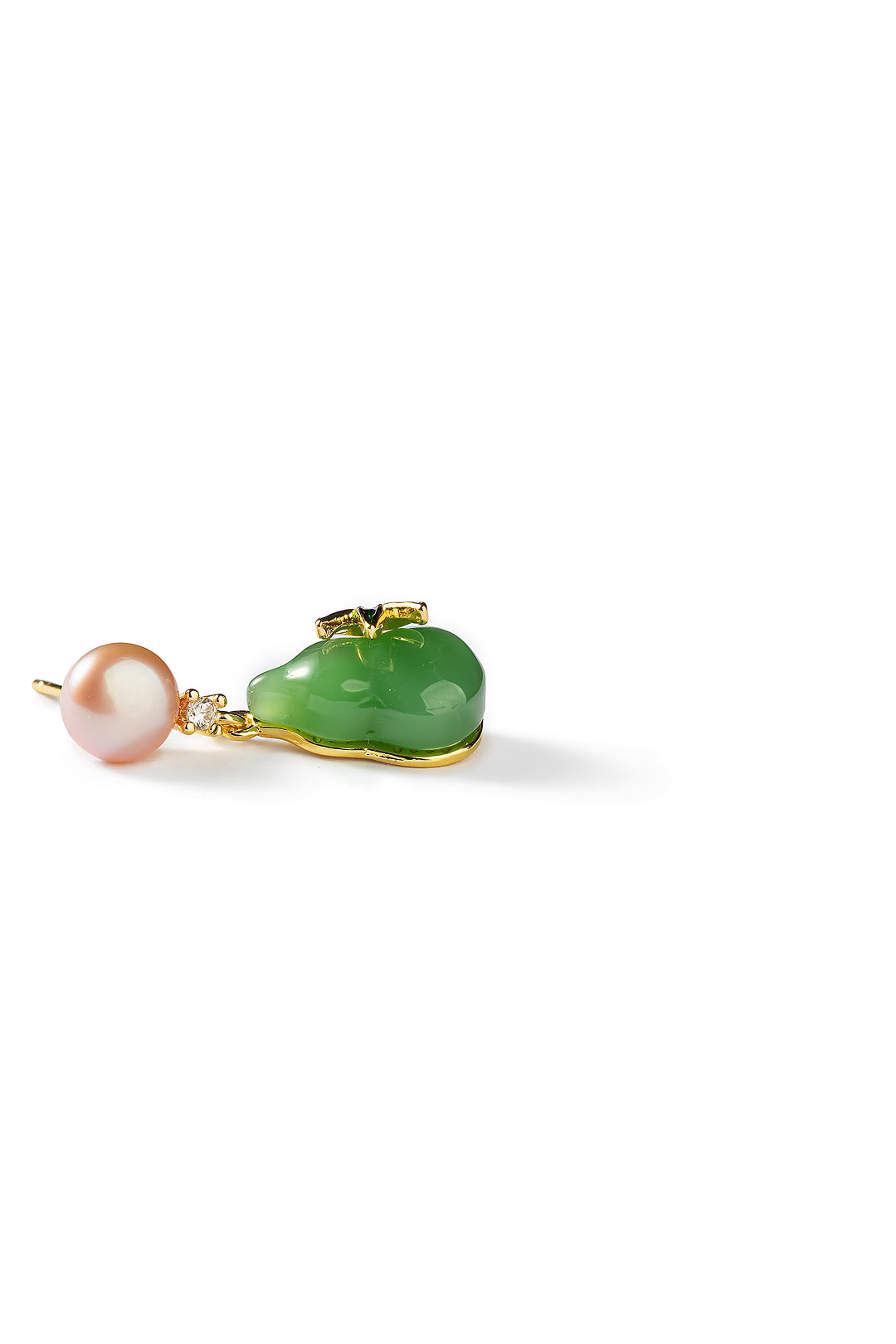 Side view of an Aiko Tanaka Hisui no Mi earring with a carved green jade gourd below a pink pearl, on white