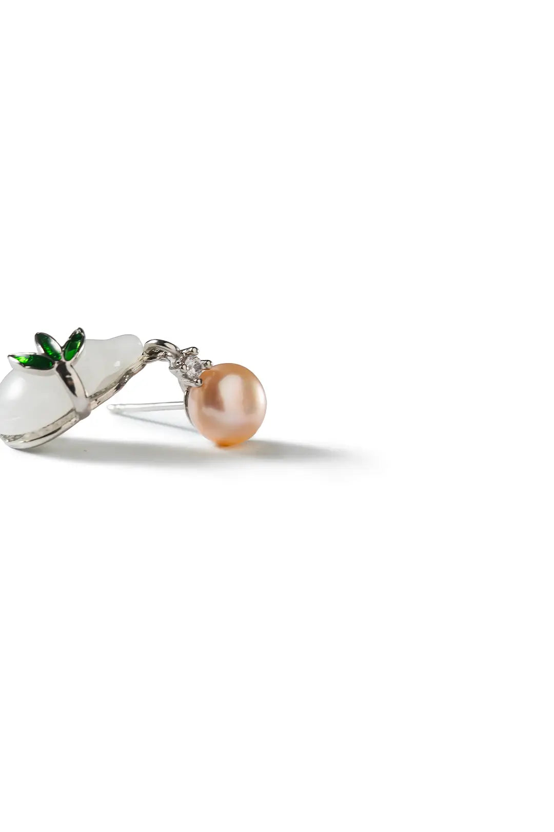 Aiko Tanaka Hisui no Mi earrings, a peach pearl stud with a white gourd drop and green leaf, on a white background