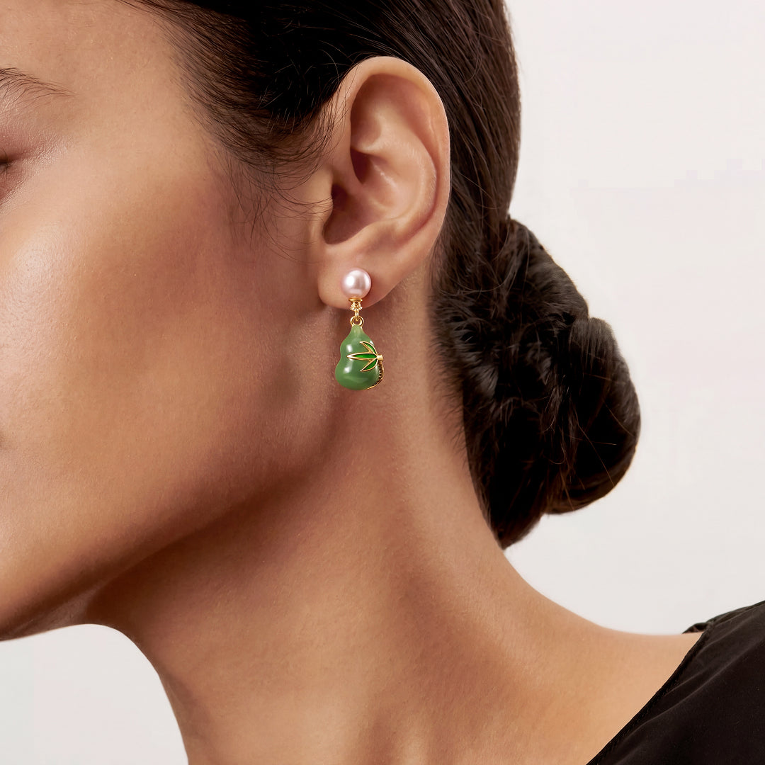Woman with a sleek bun wearing the Aiko Tanaka Hisui no Mi green jade gourd and pink pearl drop earring