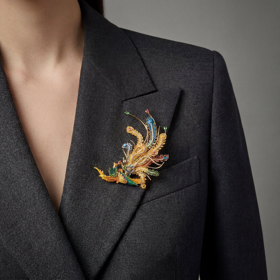 Woman in a black blazer wearing the Aiko Tanaka Hoo no Kinka gold enamel phoenix brooch on her lapel