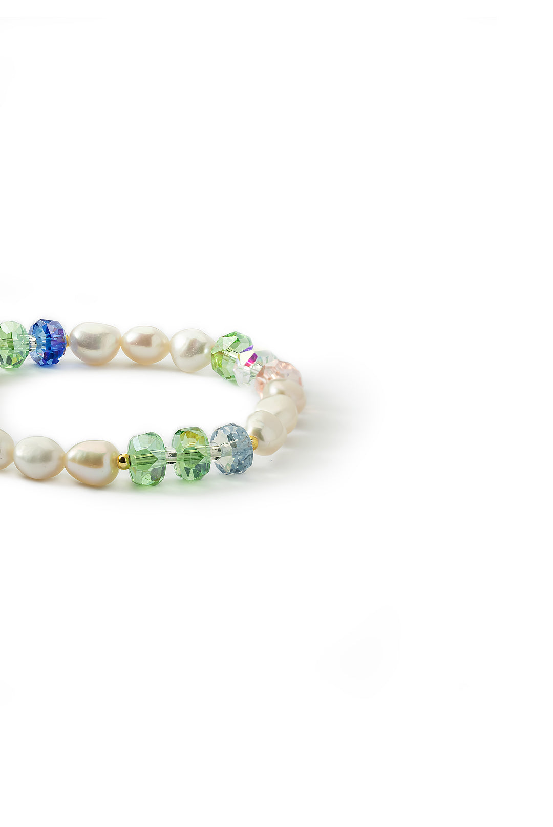 Side view of the Aiko Tanaka Hoshi no Kakera bracelet with white pearls and blue and green crystal beads, on white