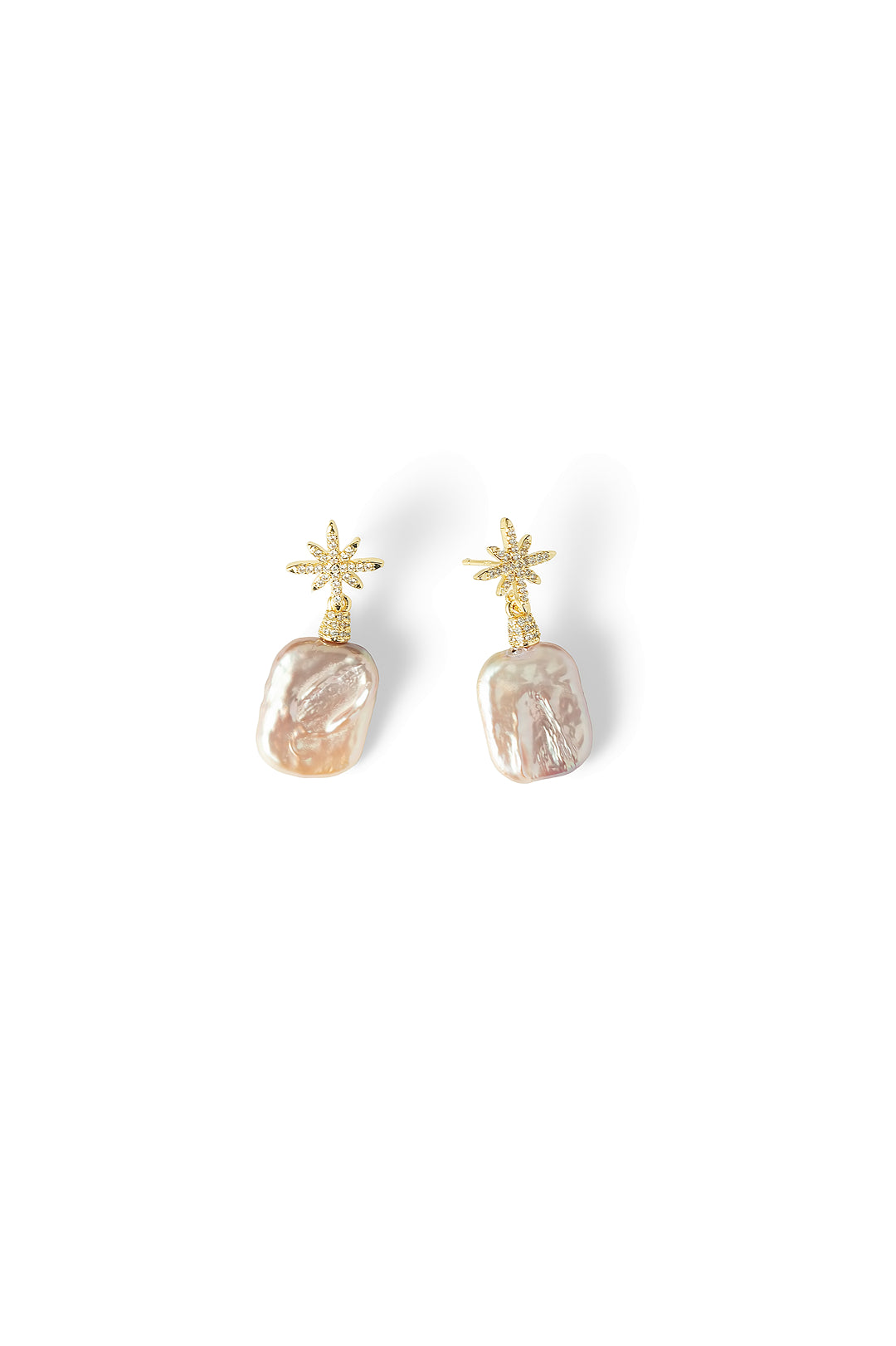 Aiko Tanaka Hoshi no Kakera earrings, gold crystal star studs holding pink-white baroque pearl drops, on white