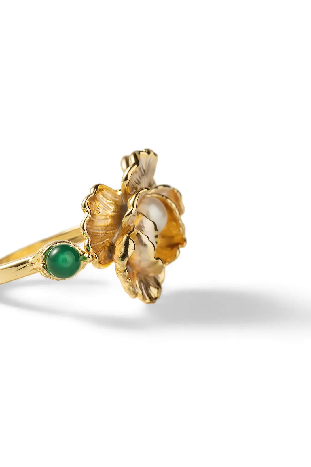Aiko Tanaka Kinsenka ring side view, a gold open band with a sculpted flower, pearl and green stone, white background