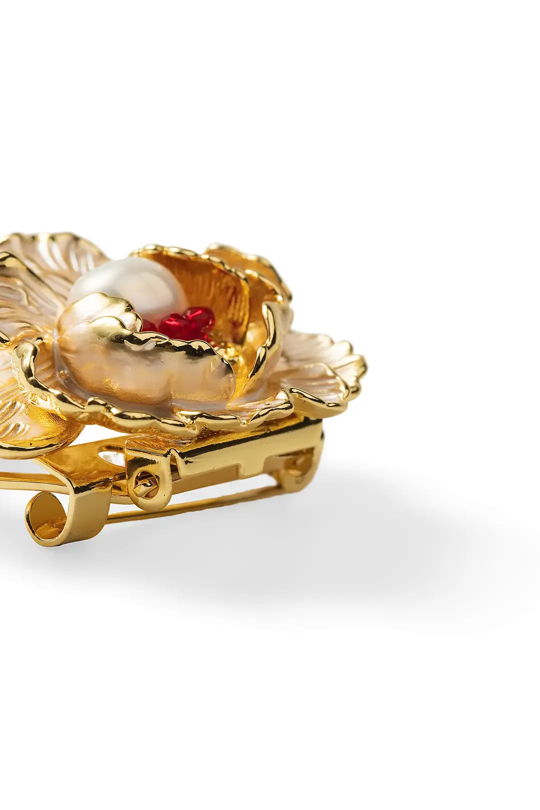 Aiko Tanaka Kohaku no Niwa brooch close-up, layered gold petals around a pearl and red stone, white background
