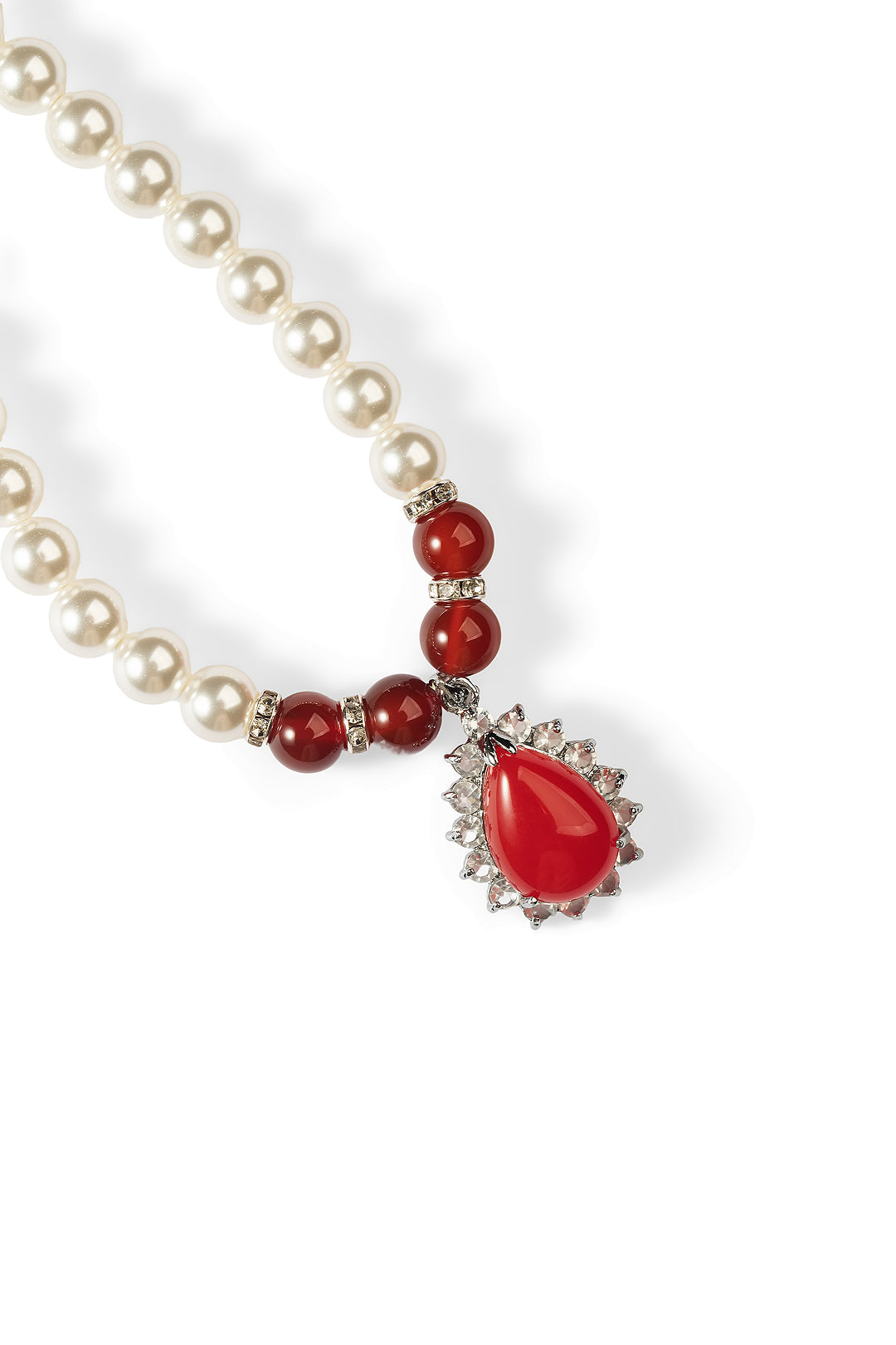 Close-up of the Aiko Tanaka Kokei pearl necklace with red beads and a red teardrop pendant edged in crystals