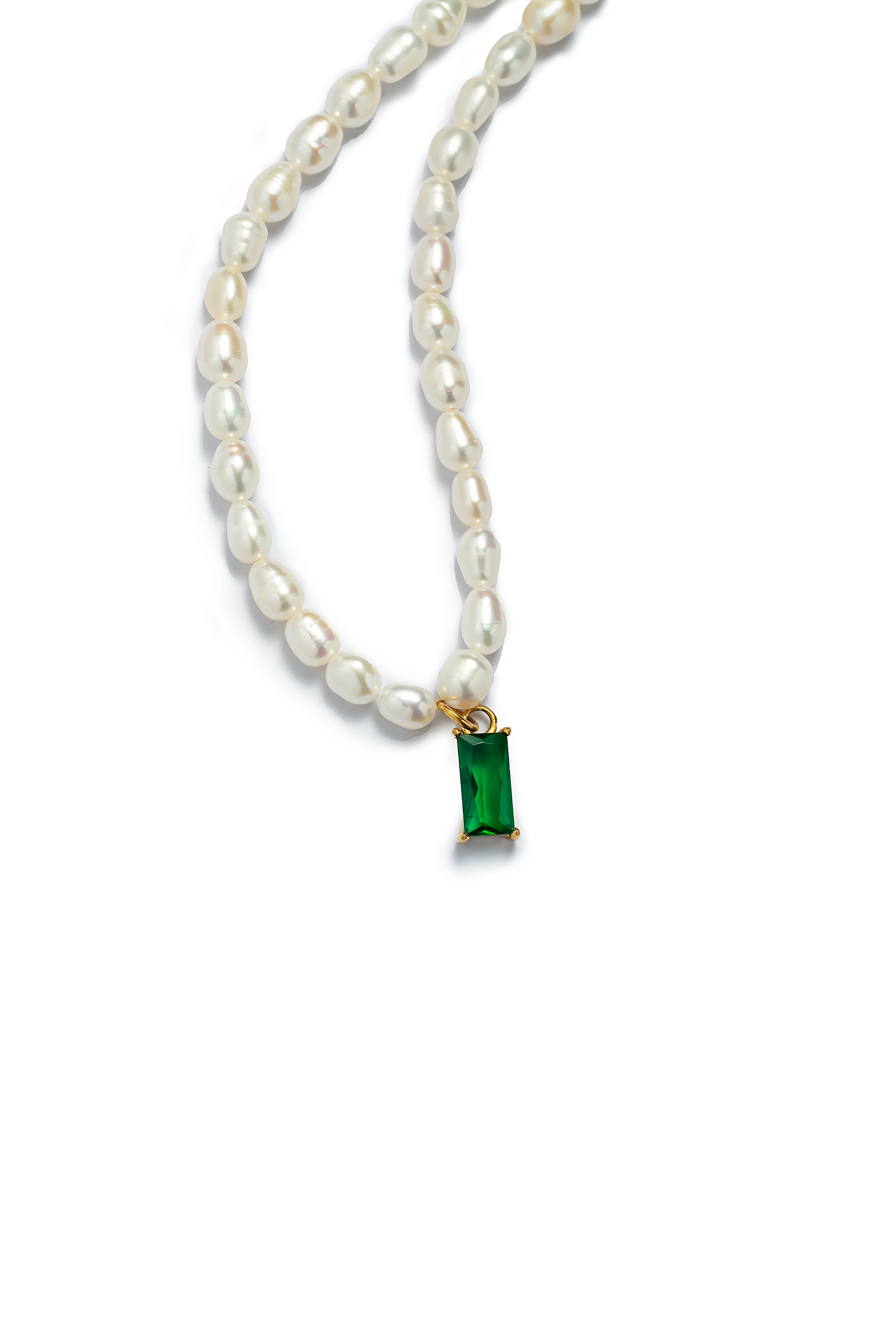 Close-up of the Aiko Tanaka Midori no Hazama freshwater pearl necklace and its rectangular green stone drop, on white