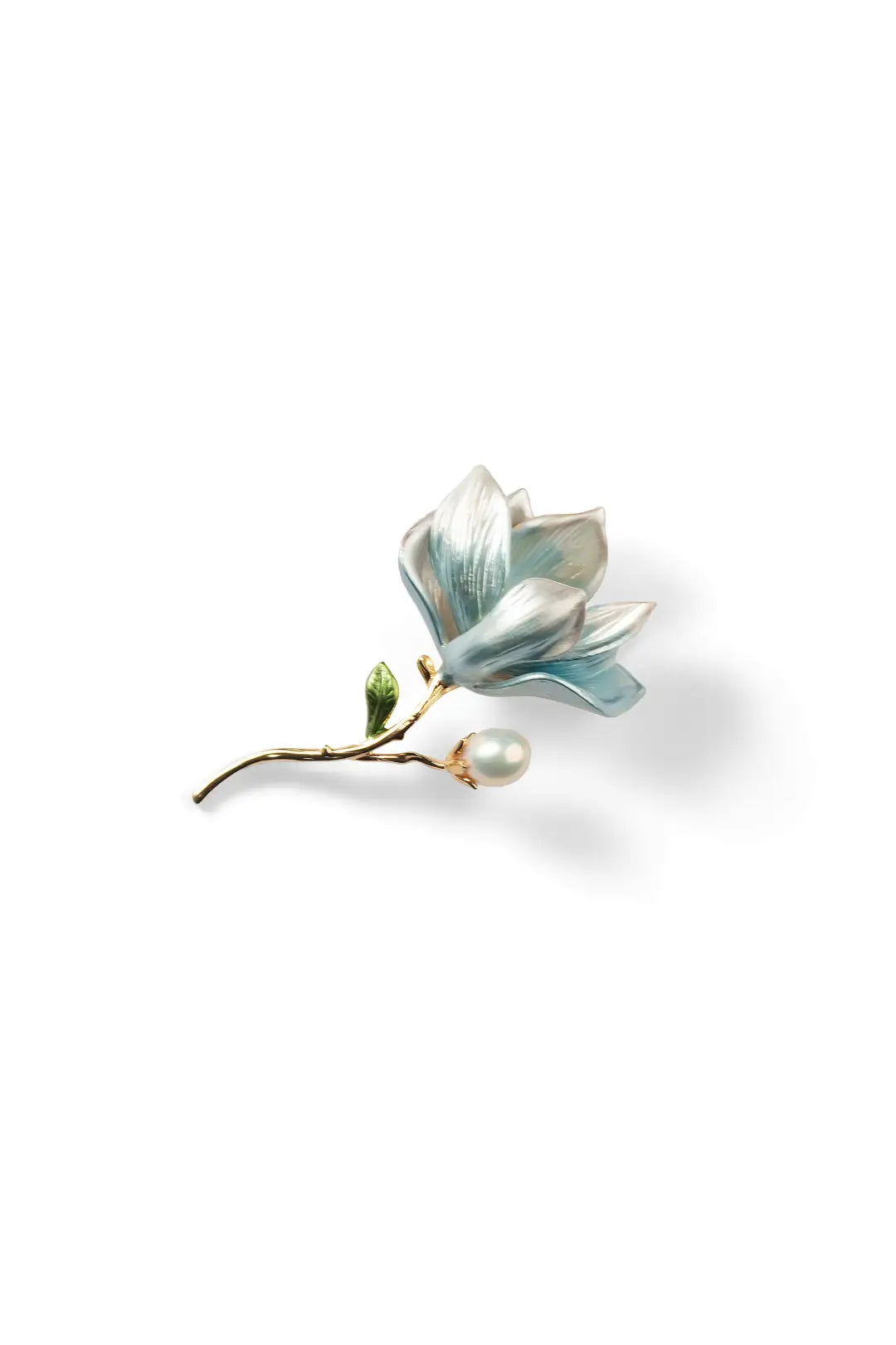 Aiko Tanaka Mizuhana brooch, a blue enamel magnolia flower on a gold stem with a white pearl, on a white background