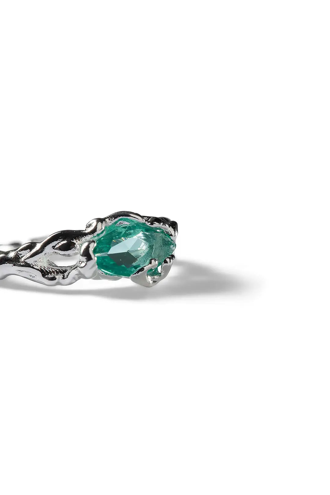 Aiko Tanaka Nami no Suisei ring, a silver wave band set with a teal marquise stone, shown on a white background