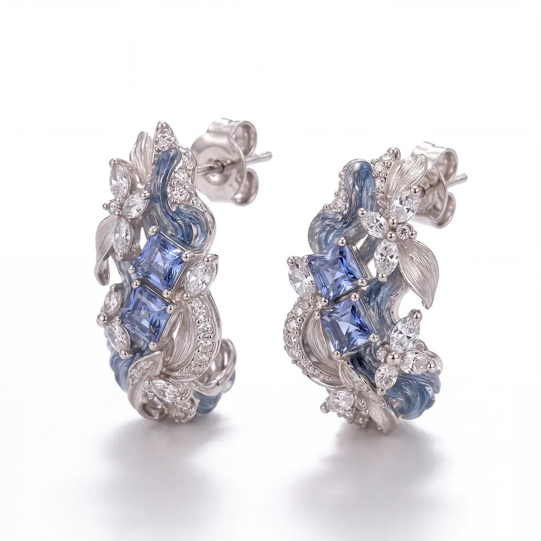 Aiko Tanaka High Jewelry No. 003 earrings, curved silver wave hoops set with blue stones, on a white background