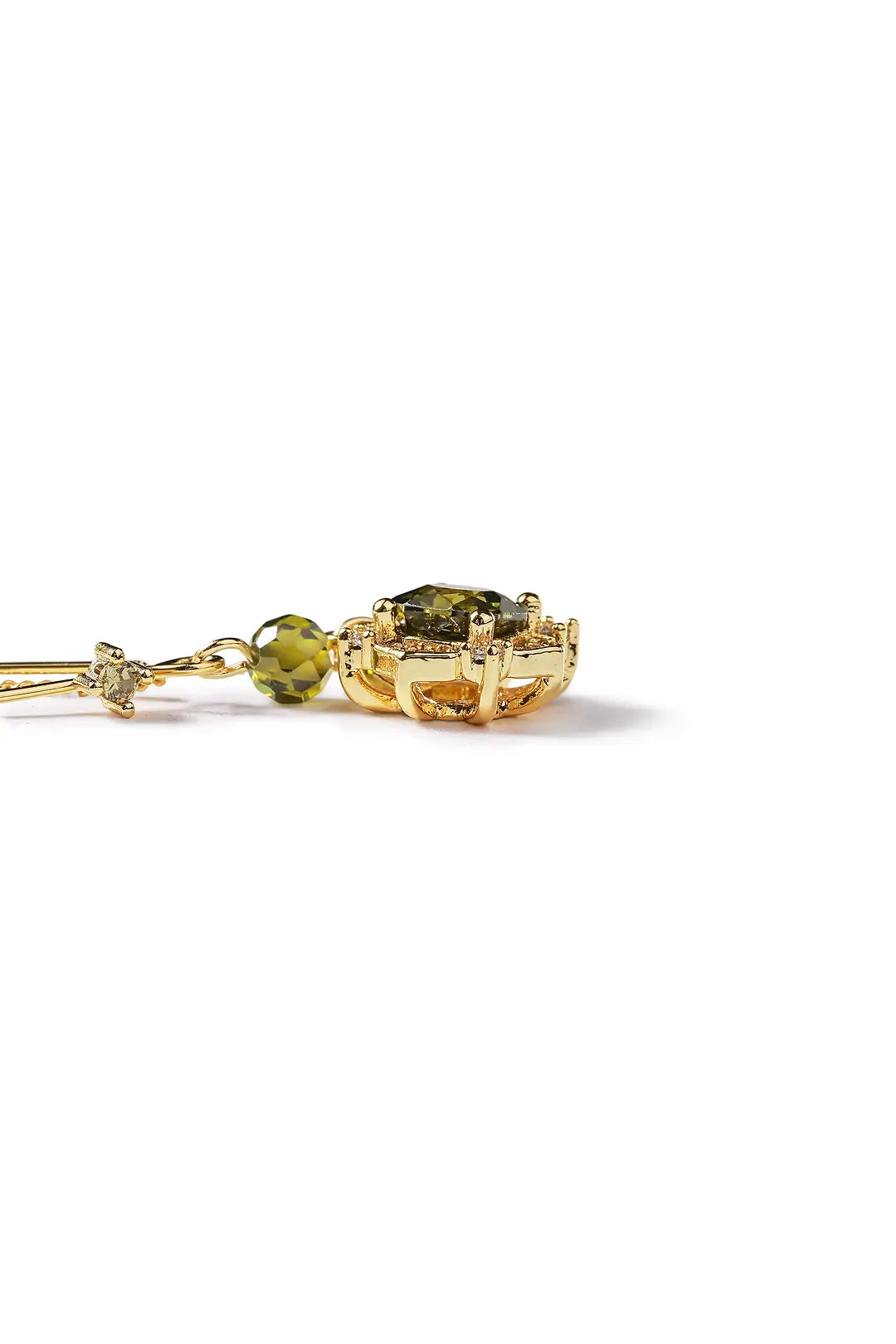 Aiko Tanaka Rensui earring lying flat, a gold threader with a green stone and crystal flower, on a white background