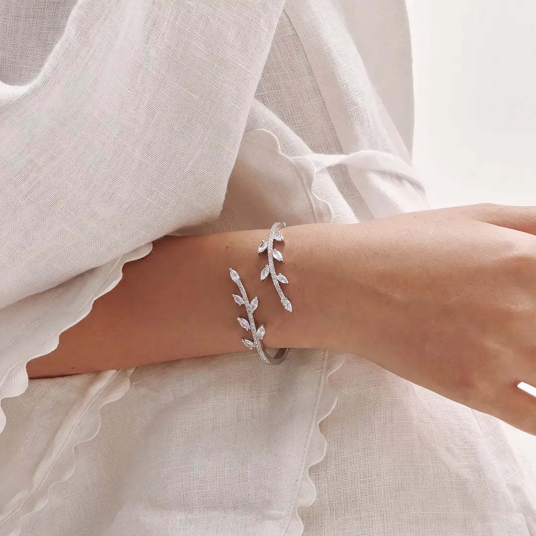 Aiko Tanaka Rinne bracelet, a silver crystal leaf vine cuff, worn on the wrist with a white linen outfit