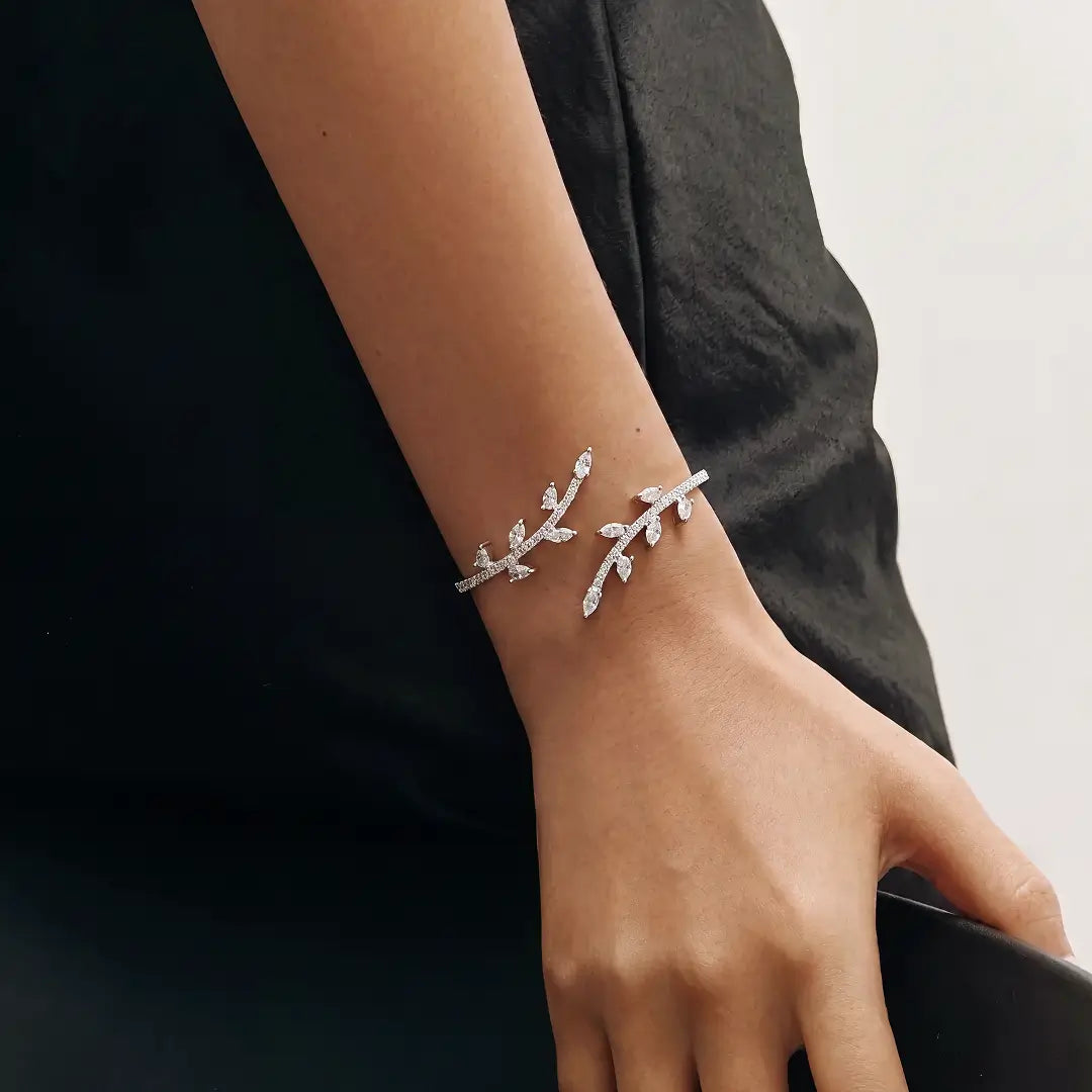 Aiko Tanaka Rinne bracelet, a silver crystal leaf branch cuff, worn on the wrist against a black outfit