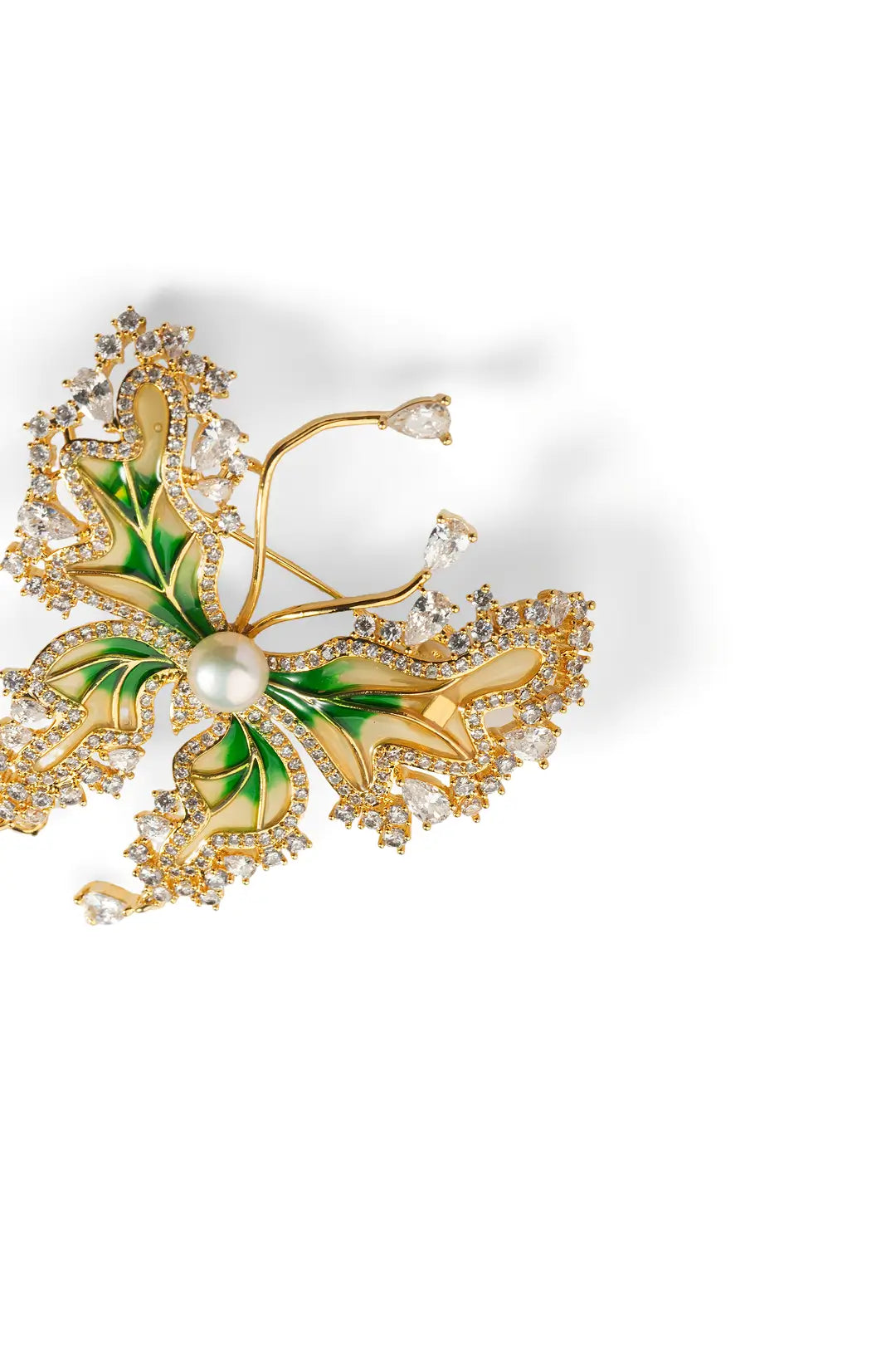 Close-up of the Aiko Tanaka Ryokucho no Mai gold butterfly brooch with green wings, crystals and a pearl, on white