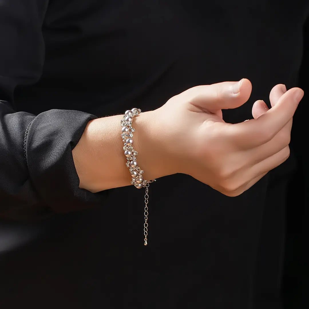 Aiko Tanaka Shirotsuyu bracelet, a silver bracelet set with pearls and crystals, worn on the wrist with a black top