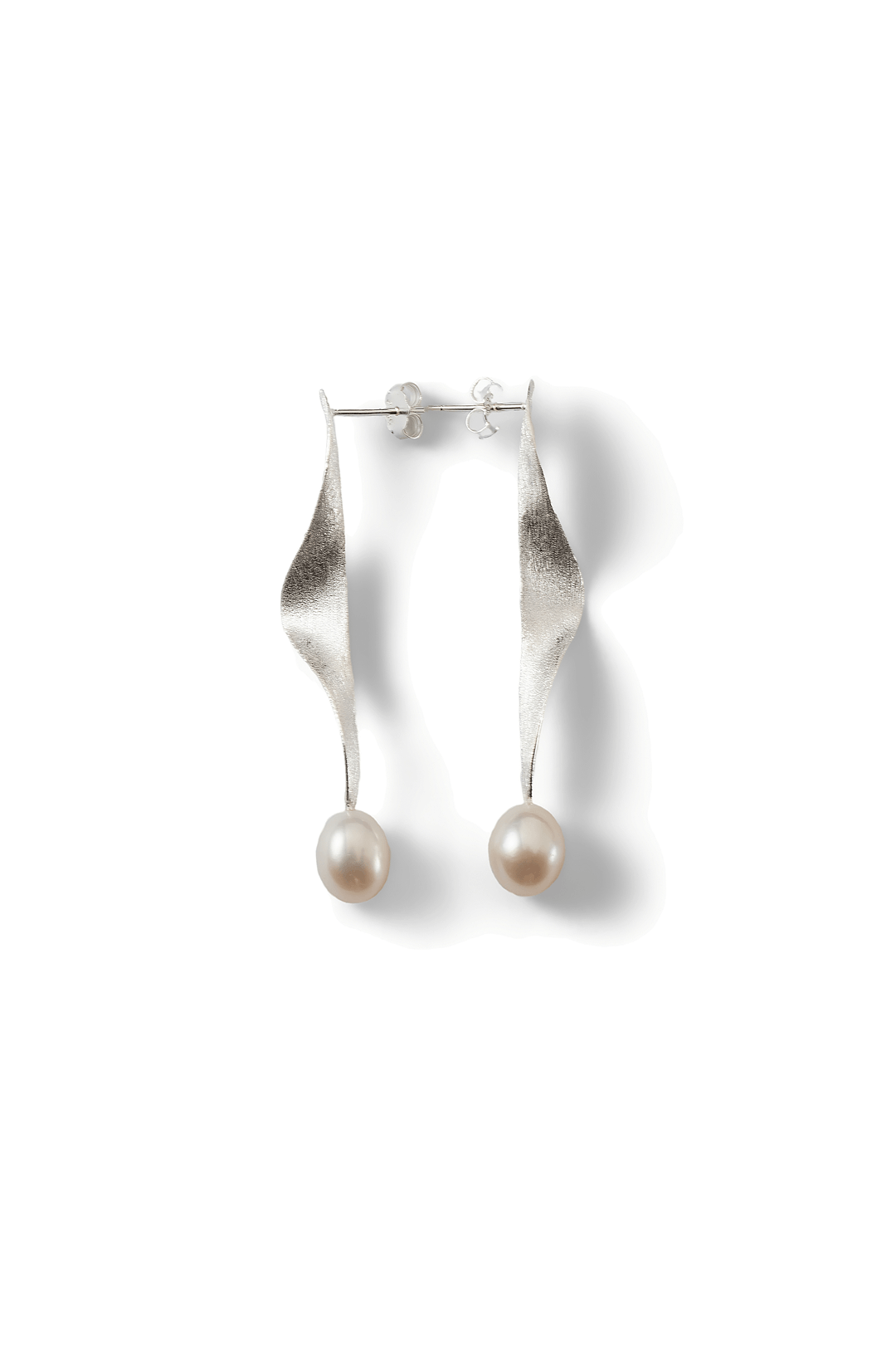 Aiko Tanaka Shizuku earrings, a pair of twisted silver ribbon drops with white pearls, shown on a white background