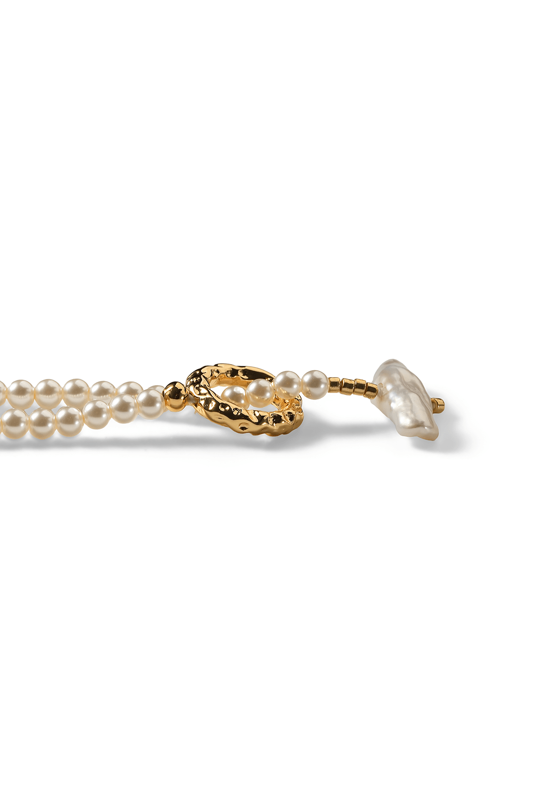 Aiko Tanaka Shizuku no Wa necklace, a seed pearl strand with a gold ring toggle clasp, lying on a white background