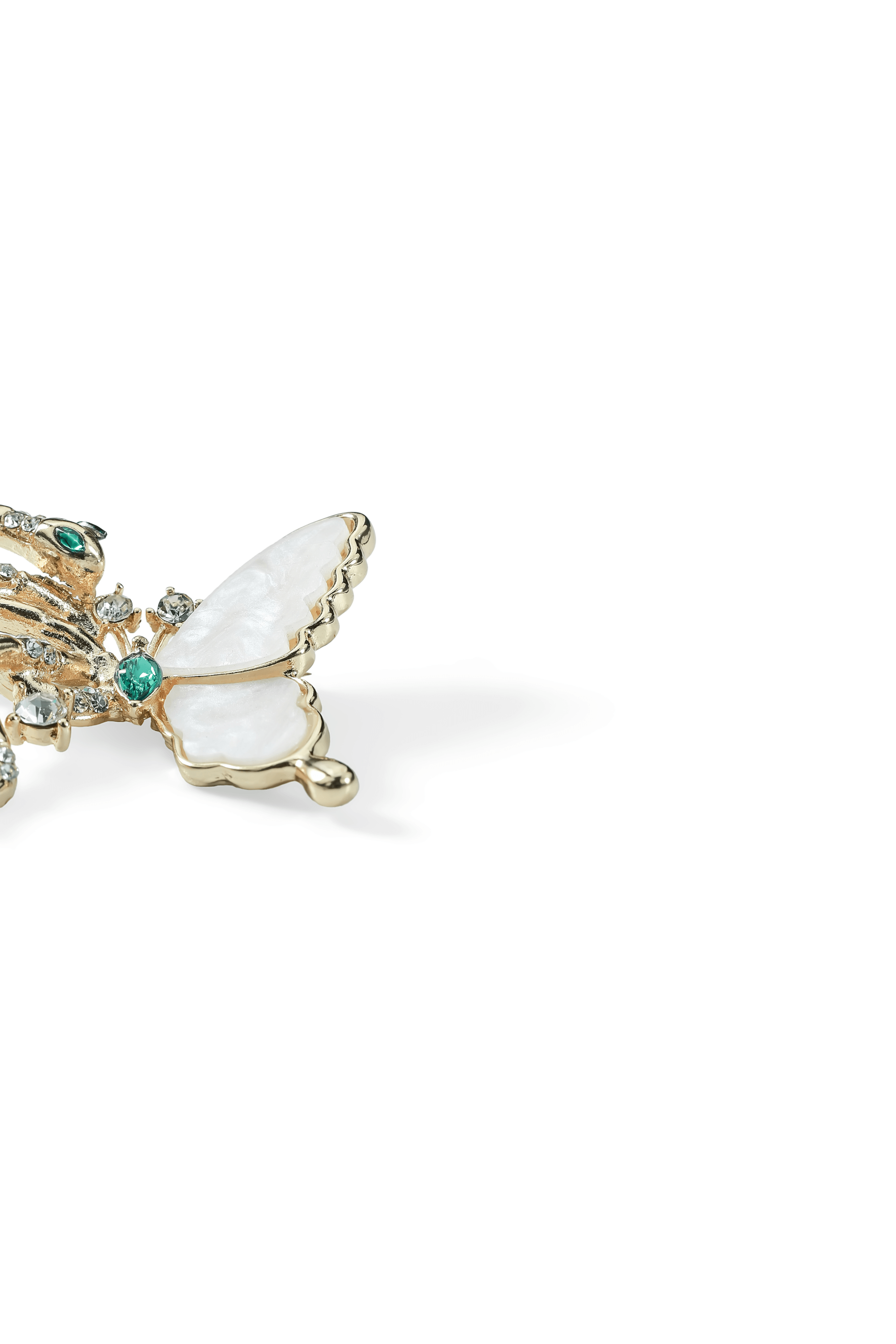Side view of the Aiko Tanaka Tsubasa no Hebi gold snake and mother-of-pearl butterfly brooch with green accents