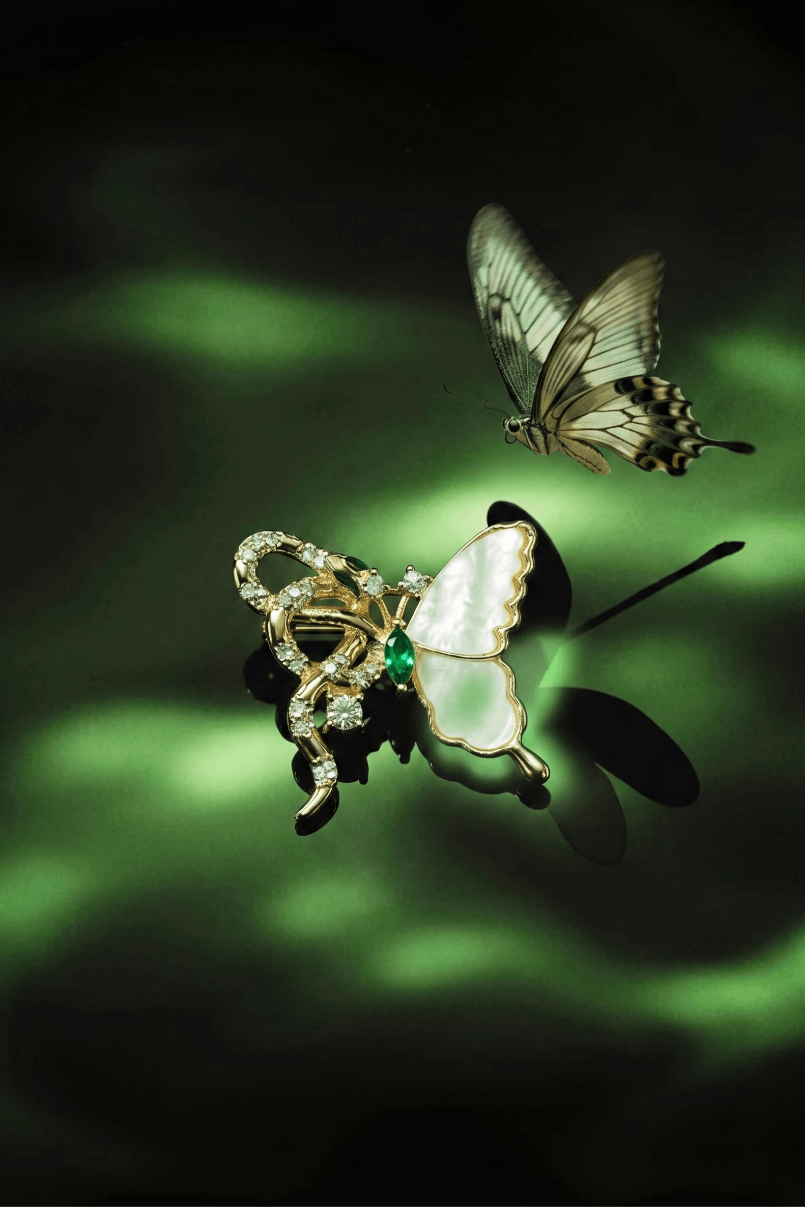 Aiko Tanaka Tsubasa no Hebi snake and mother-of-pearl butterfly brooch beside a live butterfly in dappled green light