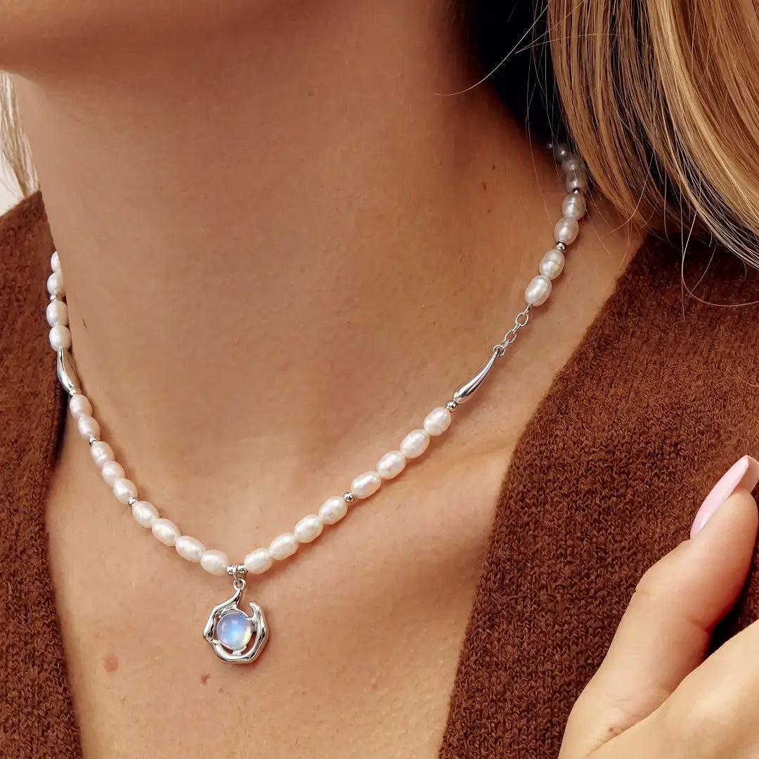 Aiko Tanaka Ukifune necklace, white freshwater pearls with a blue moonstone pendant, worn with a brown cardigan