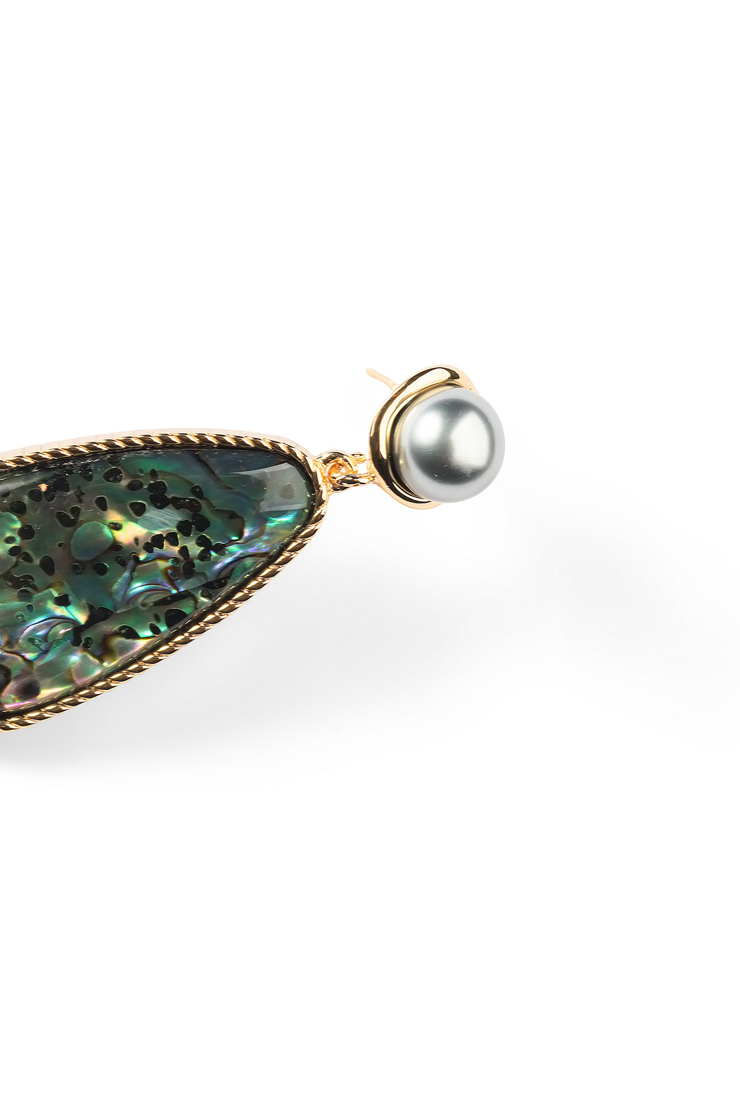 Side view of an Aiko Tanaka Umi no Kagami earring, an iridescent abalone teardrop in gold below a grey pearl