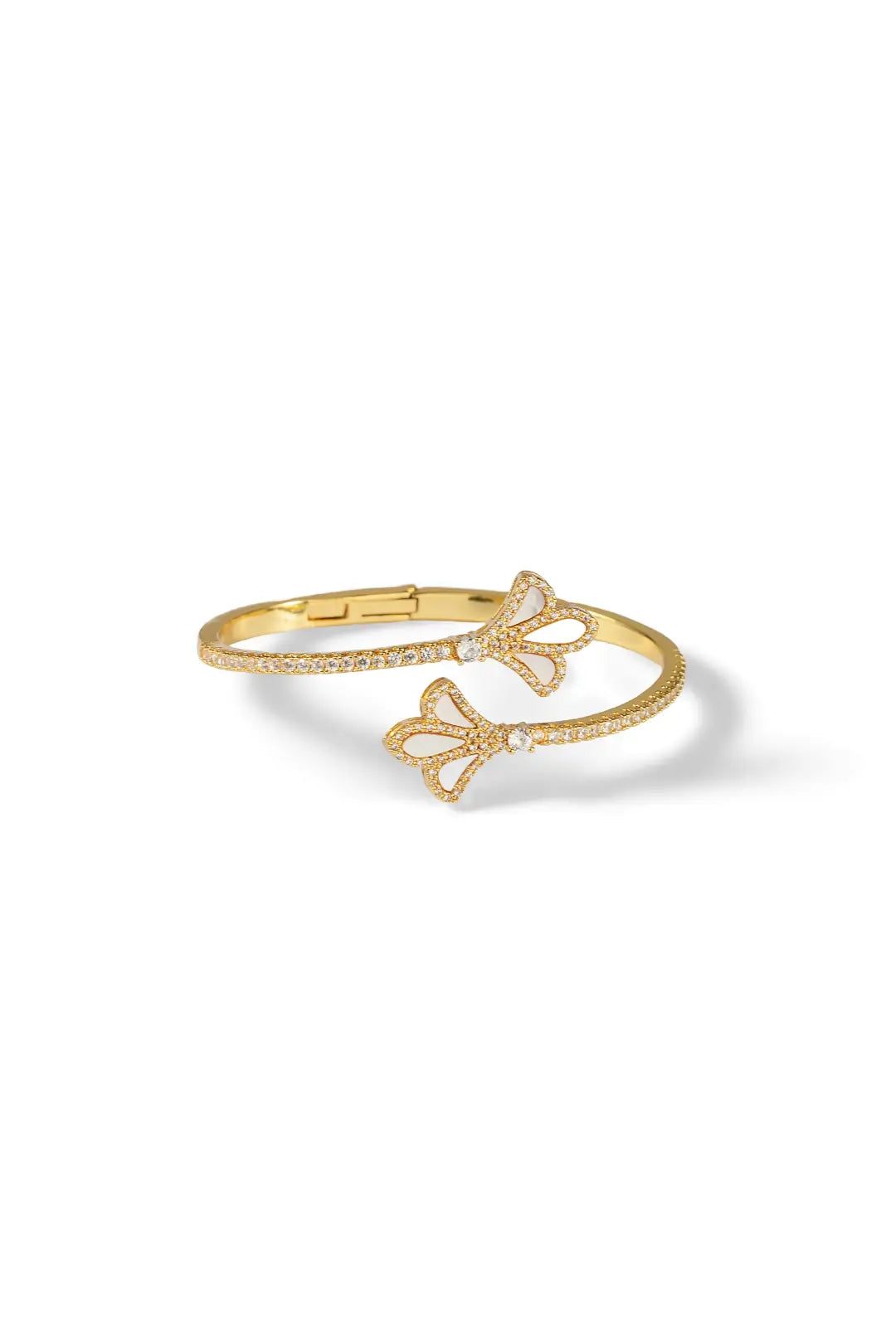 Aiko Tanaka Yohaku bracelet, a gold open cuff ending in two ginkgo leaves, angled view on a white background