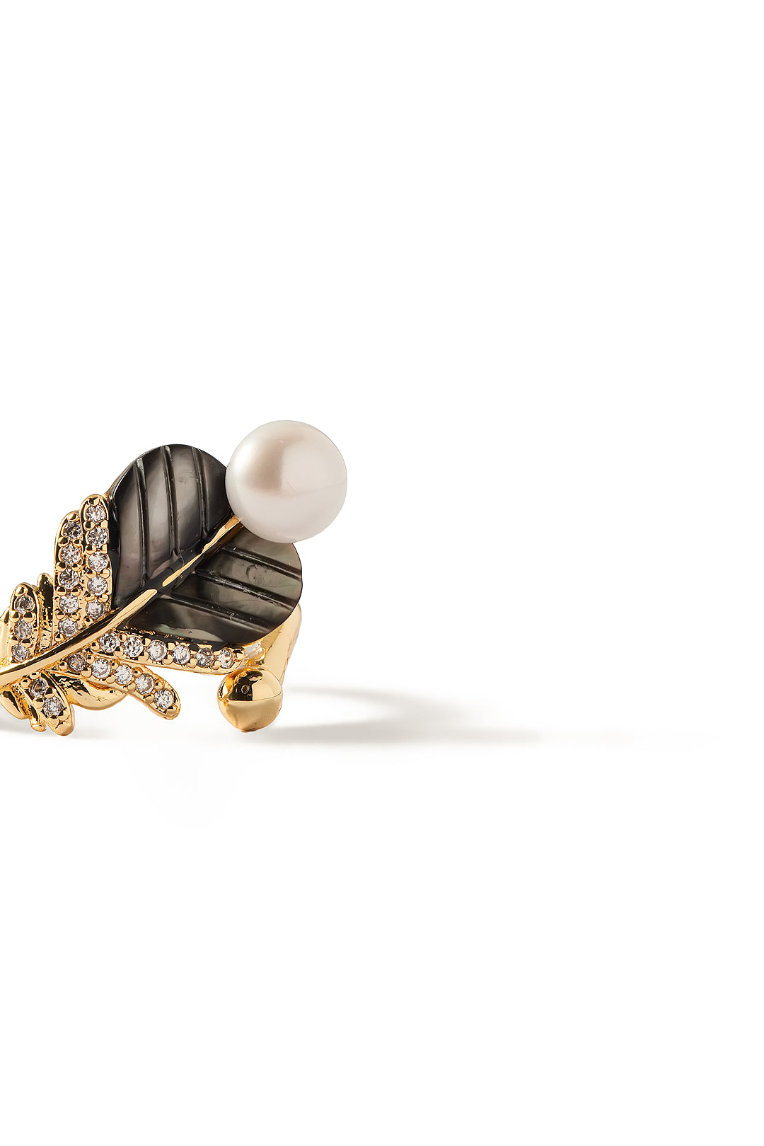 Side view of the Aiko Tanaka Yoru no Ha gold leaf ring with a dark shell leaf, crystal veins and a white pearl
