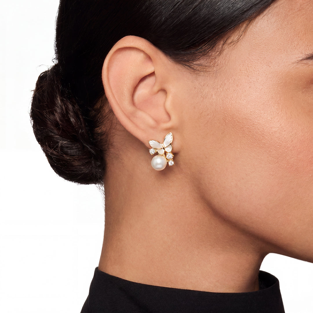 Woman with a low bun wearing the Aiko Tanaka Yuki Cho butterfly and pearl earring with a black turtleneck